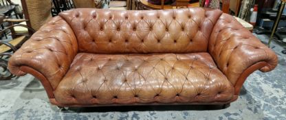 Office Chesterfield brown leather upholstered sofa having a buttoned back, scroll arms and seat,