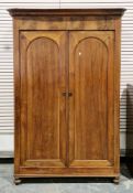 Victorian walnut wardrobe/cupboard, the moulded cornice over two arched panel doors opening to an