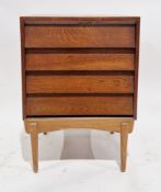 Mid-century teak chest comprising four long drawers with sloping fronts, on a base with four