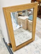 Modern pale oak framed mirror of rectangular form with bevelled edge, 92cm x 61.5cm