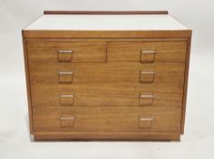 Mid-century Remploy teak military chest, the rectangular top with short back upstand and formica