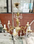 Mid-20th century gilt brass six-branch electrolier in the rococo manner, with prismatic glass