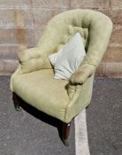 Early 20th century buttonback green upholstered armchair on square tapering legs with castors,
