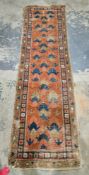 Persian Heriz type red and blue ground wool rug decorated with geometric motifs within three