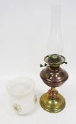 Early 20th century brass and copper oil lamp having an opaque embossed glass shade with frilled