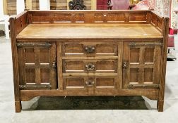 Arts & Crafts style oak sideboard, the top with three-quarters panelled back rail, comprising