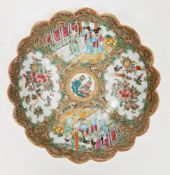 Late 19th century Canton famille rose fluted circular dish painted with figures standing in