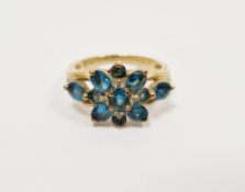 9ct yellow gold and blue topaz flower cluster ring comprising eleven claw-set mixed cut oval and