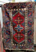 Turkish Dosemealti type red and blue ground wool rug, decorated with three cross shaped medallions