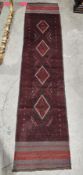 Meshwani runner, 20th century, dark red lozenges woven on a grey ground within geometric borders,