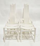 In the manner of Charles Rennie Mackintosh a set of four white painted dining chairs with stylised