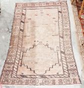 Persian red ground wool rug, decorated with two medallions in a border, 171cm x 94cm