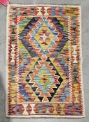 Chobi kilim, 20th century, of small size, with interlocking geometric lozenges, in bold palette on a