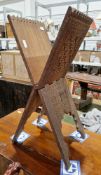 Indian hardwood folding Koran stand, the exterior profusely carved with flowers within a border, the
