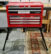Two Clarke red tool drawer cabinets and a collapsible stand