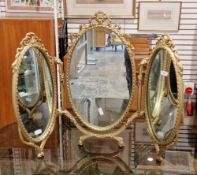 Mid-20th century gilt metal triptych dressing mirror in the French rococo style, the three oval