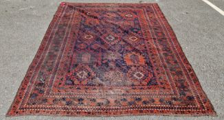 Persian wool blue ground rug, decorated with rows of geometric medallions within a deep border