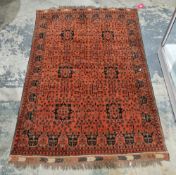 Afghan Ersari type red ground wool rug, decorated with six medallions surrounded by small flowers