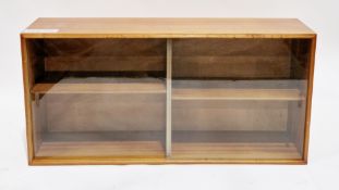 Mid-century teak low library bookcase with two glass sliding doors, each opening to an adjustable