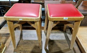Pair of mid-20th century beechwood kitchen stools with red leatherette upholstered seats, on