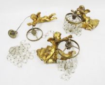 Set of three wall lights in the form of three gilt plaster cherubs holding glass drop crystal