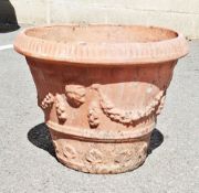 Large terracotta plant pot decorated with foliate swags, 44cm high x 57cm diameter