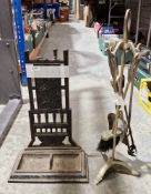 Cast iron stickstand and a gilt metal fireside companion set