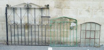 Two wrought scrollwork garden gates, largest 129cm x 132cm and a twelve-pane arched iron framed
