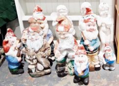 Collection of distressed painted garden gnomes in fibreglass, of varying sizes, 37-86cm high and