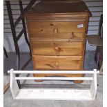 Three-drawer pine bedside table, a white painted wall-mounting towel rail and a grey painted ascanth