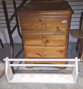 Three-drawer pine bedside table, a white painted wall-mounting towel rail and a grey painted ascanth
