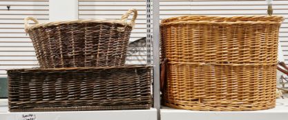 Contemporary wicker oval two-handled log basket and cover with brown leather handles, containing a