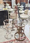 Collection of wrought and cast garden metal items including torchere stands, hanging baskets and