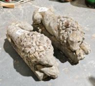 Pair of cast stone lions couchant, 47cm long (2)