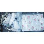 Four bags of assorted fabrics including various floral examples, an animals in hot air balloons sect