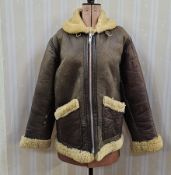 A vintage sheepskin jacket, flying jacket style, leather zip fastening labelled Douglas real