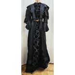 A black Victorian probably mourning dress, with cut velvet detail to the inner bodice, appliqued