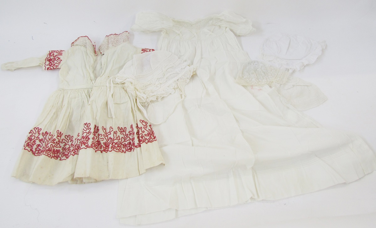 A child's vintage dress, cotton, embroidered with ribbon detail in red panel on the bodice,