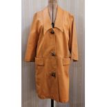 Vintage 1970's orange leather coat, three-button metal fastening, pockets and a shawl collar, and