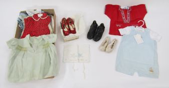 Various children and baby clothes to include smocked dresses, smocked silk baby gowns, a red wool