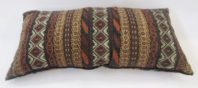 A bolster cushion, the covers Turkish saltbags, 95cm long x 40cm wide approx. Condition Report The