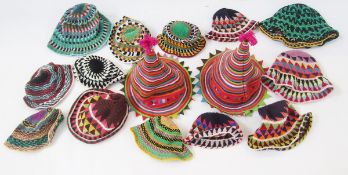 Two cotton tie carnival hats and a quantity of ethnic crocheted bucket hats in various sizes and