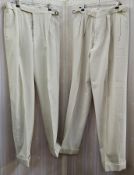 Two pairs of gent's cream flannel trousers labelled Gieves Ltd, fly button fastening, turn-ups, size