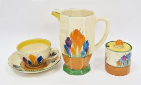 Clarice Cliff 'Crocus' pattern jug (15.5cm high), a cup & saucer and a lidded preserve jar (lid