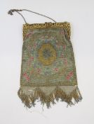 A beaded late 19th century/early 20th century evening bag, the gilt metal fixed frame is carved with