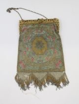 A beaded late 19th century/early 20th century evening bag, the gilt metal fixed frame is carved with