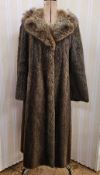 A vintage fur coat, full length, possibly beaver with a racoon collar