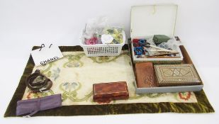 Various faux flowers, dress/hat adornments, a small Chanel carrier bag, a pair of wooden glove