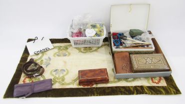 Various faux flowers, dress/hat adornments, a small Chanel carrier bag, a pair of wooden glove