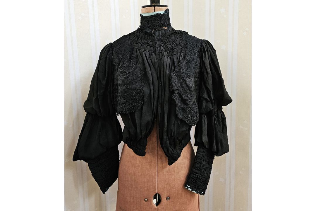 A black Victorian open-work skirt with pleated flounces and lace trim, the final flounce is - Image 1 of 3